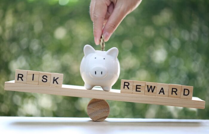 Wording,Risk,And,Reward,On,Wood,Block,On,Natural,Green